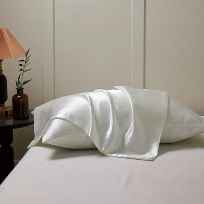 Pair of solid colour satin pillowcases showing smooth plain weave texture and reactive dye colour