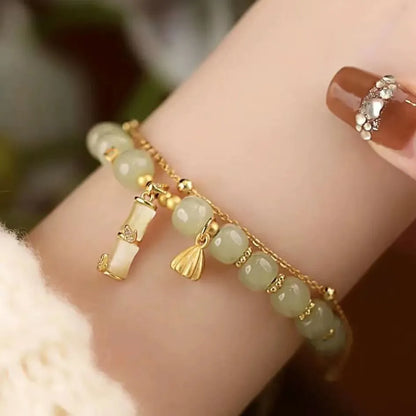 Retro bamboo design bracelet with floral shape and ruyi element in glass and coloured glaze