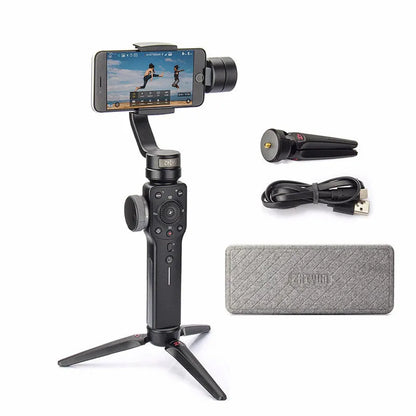 Black mobile phone handheld stabiliser gimbal on table with smartphone mounted