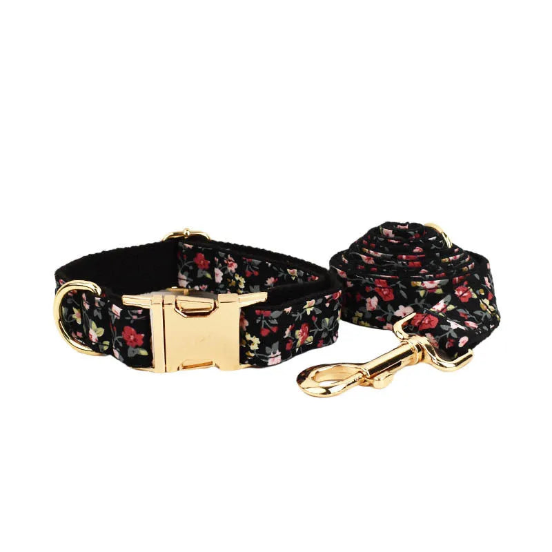 Four-piece dog accessory set showing a cloth collar, leash, vest, and removable bow with printed lettering.