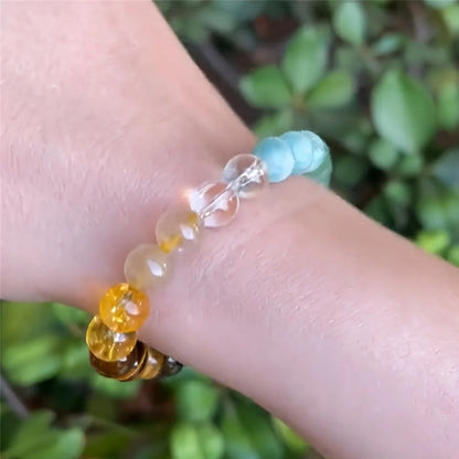 Adjustable natural crystal bracelet showing 15mm beads on elastic cord in blue colour variation