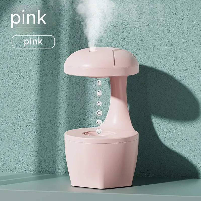 White, pink, and green column-shaped USB-powered ultrasonic humidifier.