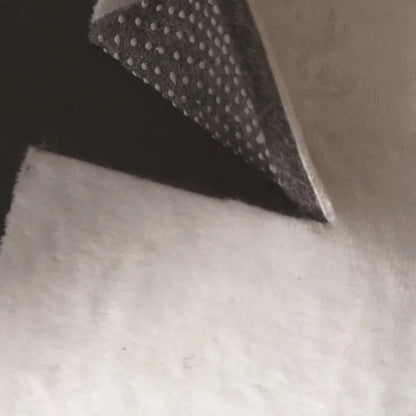 Black rectangular bedside carpet with anti-skid plastic points on bottom and soft felt interior.