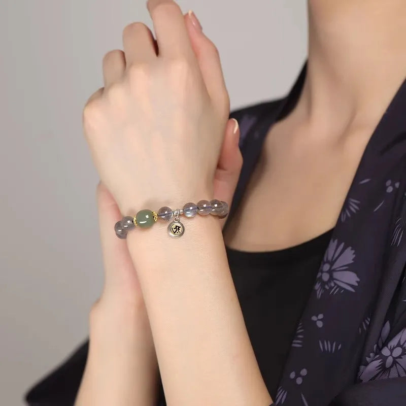 Birth Buddha Beads bracelet, a women's bracelet featuring genuine moonstone crystal beads in an 8mm size, electroplated finish, and showcasing the Thousand-Hand Kwan-yin mouse zodiac animal style for a personalised spiritual accessory.