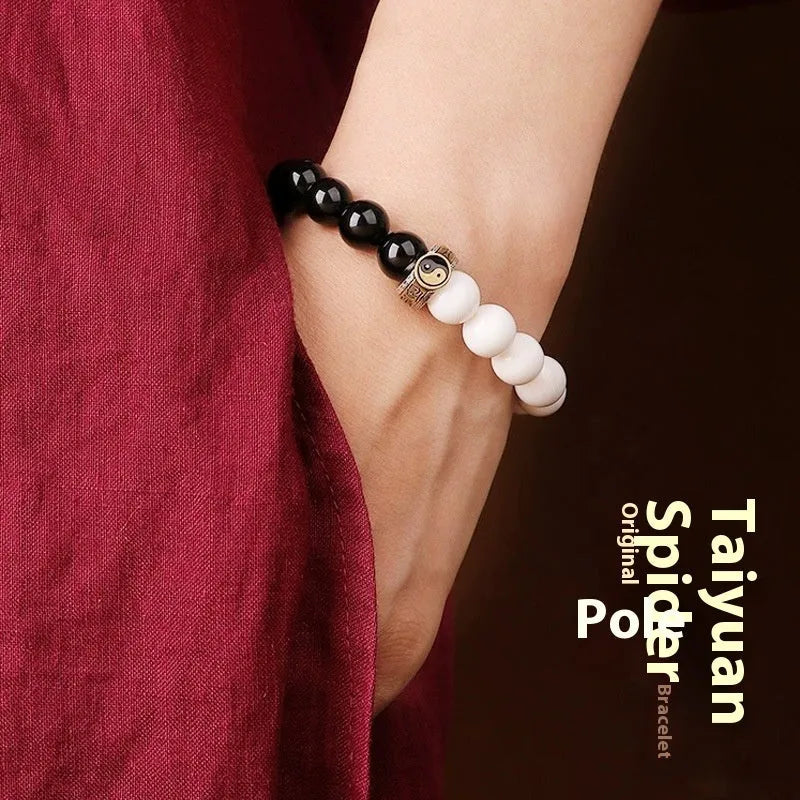 Black and white Tai Chi bracelet with obsidian beads and six-word mantra in geometric pattern