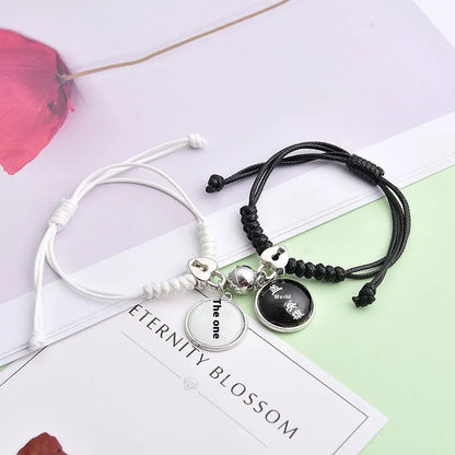 A pair of magnet couple bracelets with a suction clasp, showing various design options like clovers, crowns, and hearts.