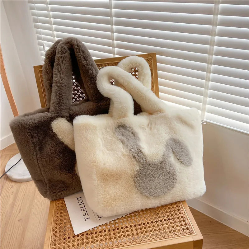 Soft plush tote bag with cartoon rabbit ears in solid colours like beige, pink, and black.