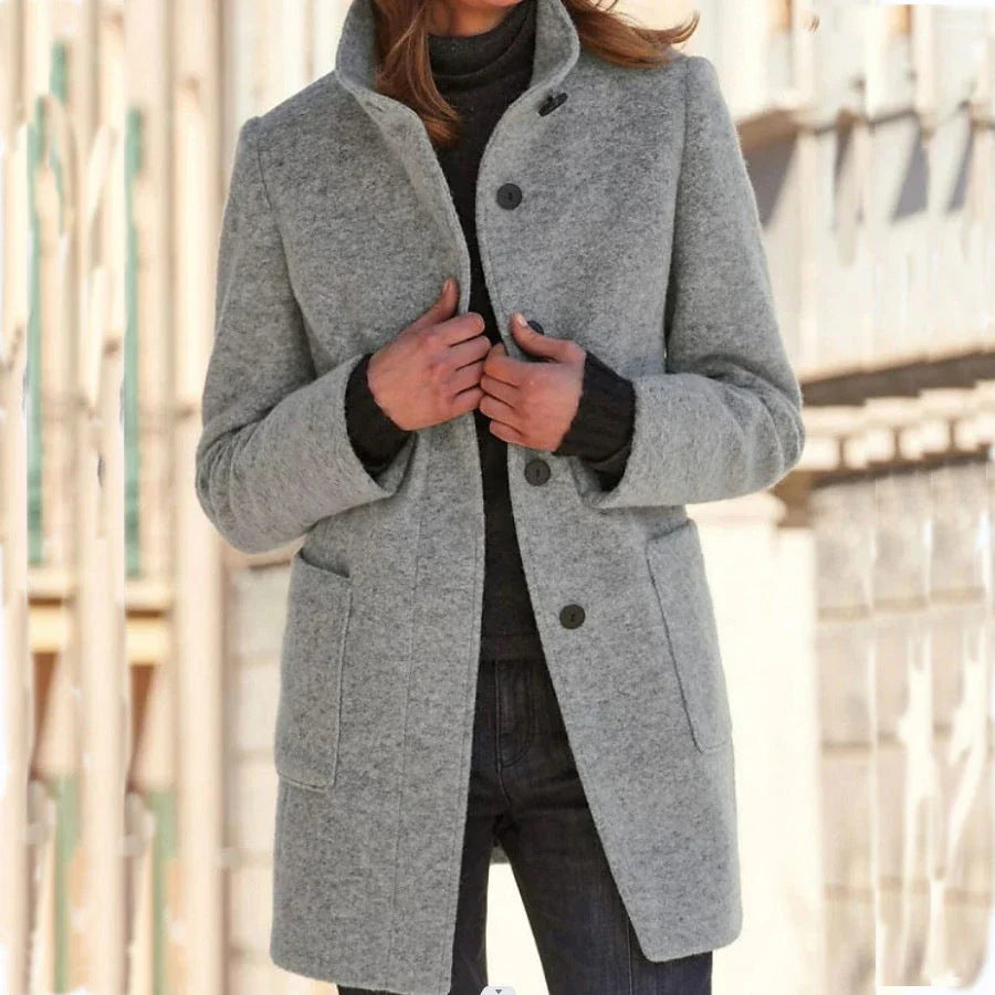 Stylish wool coat with stand collar, pockets, and slim fit design for casual winter wear.