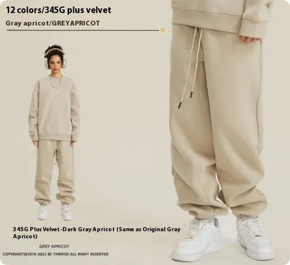 Man wearing solid colour cotton velvet sweatpants with an ankle banded design in a dark grey shade.