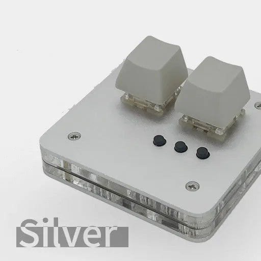 Mini USB wired keyboard in white, light grey, black, or pink colour on a desk.