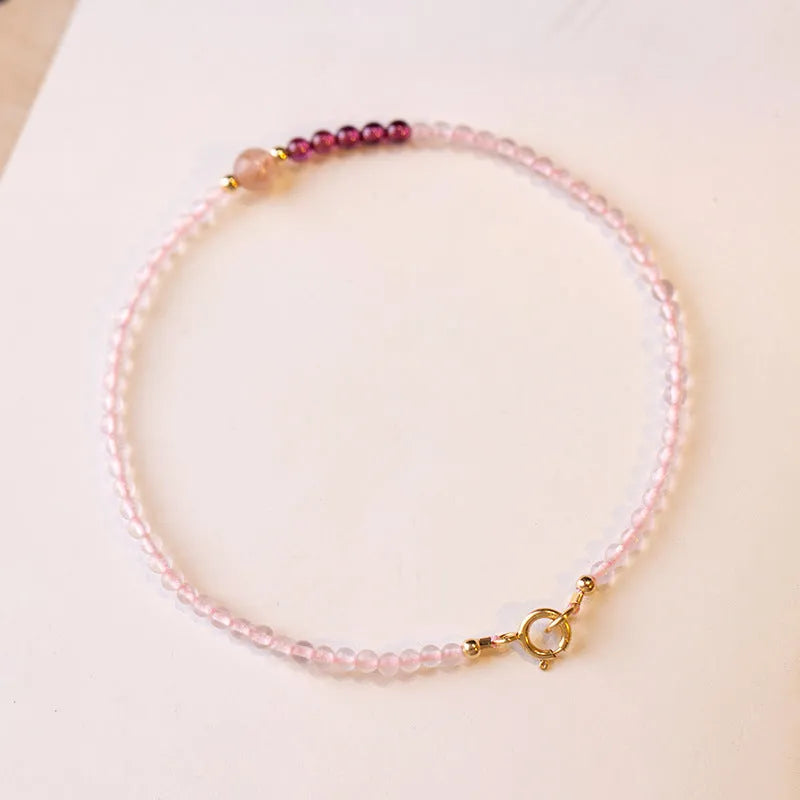 Handmade pink crystal bracelet with strawberry quartz charm showing 2mm beads