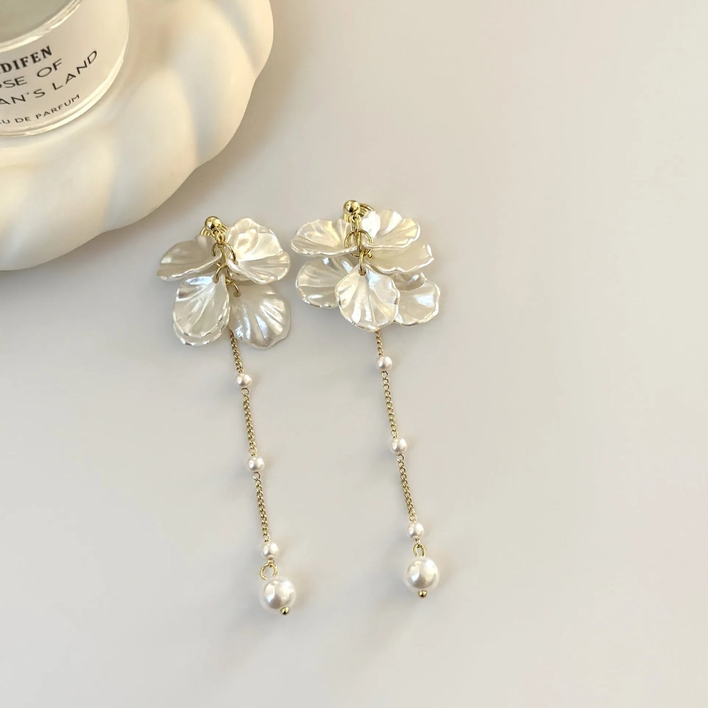 Women's acrylic shell pearl tassel earrings showing four ear clip types and casual style design