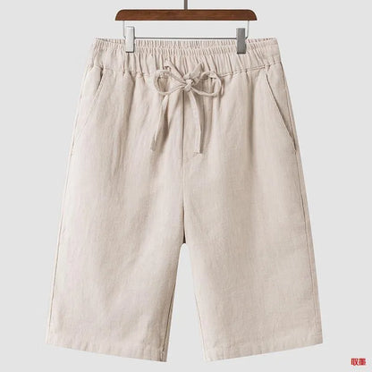 Men's beige linen casual shorts with a loose fit and elastic waistband on a neutral background.