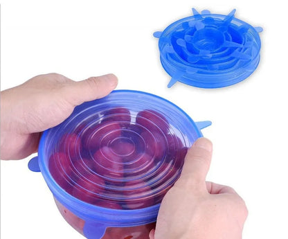 Set of six flexible silicone pot lids in assorted sizes on a kitchen counter.
