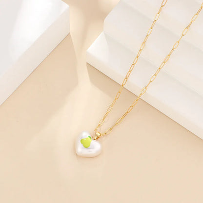 Geometric fruit heart pendant necklace on an adjustable chain, showing strawberry, pineapple, apple, pear, and cherry design options.