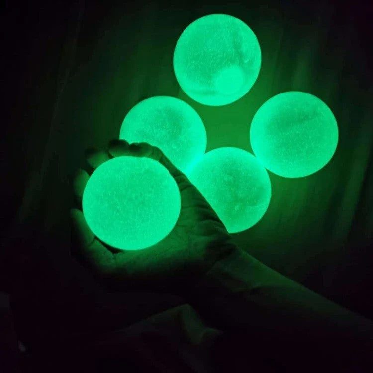 Colorful, luminous stress relief balls with a sticky surface for bouncing, squeezing, and sticking to surfaces