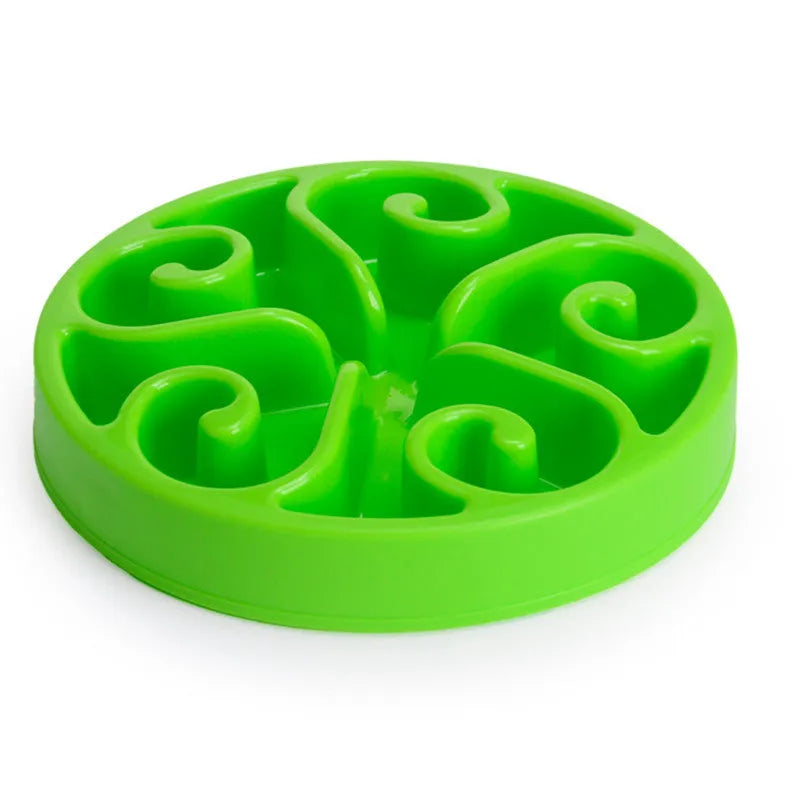 Coloured plastic dog slow feeder bowl showing internal maze pattern and ridges, with wide non-slip base