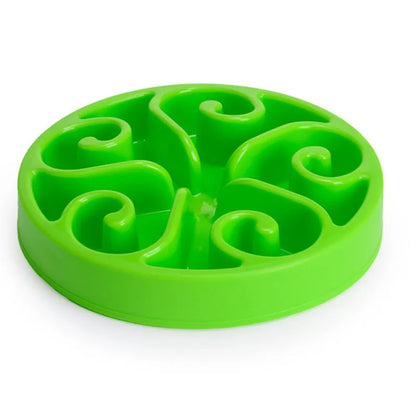 Coloured plastic dog slow feeder bowl showing internal maze pattern and ridges, with wide non-slip base