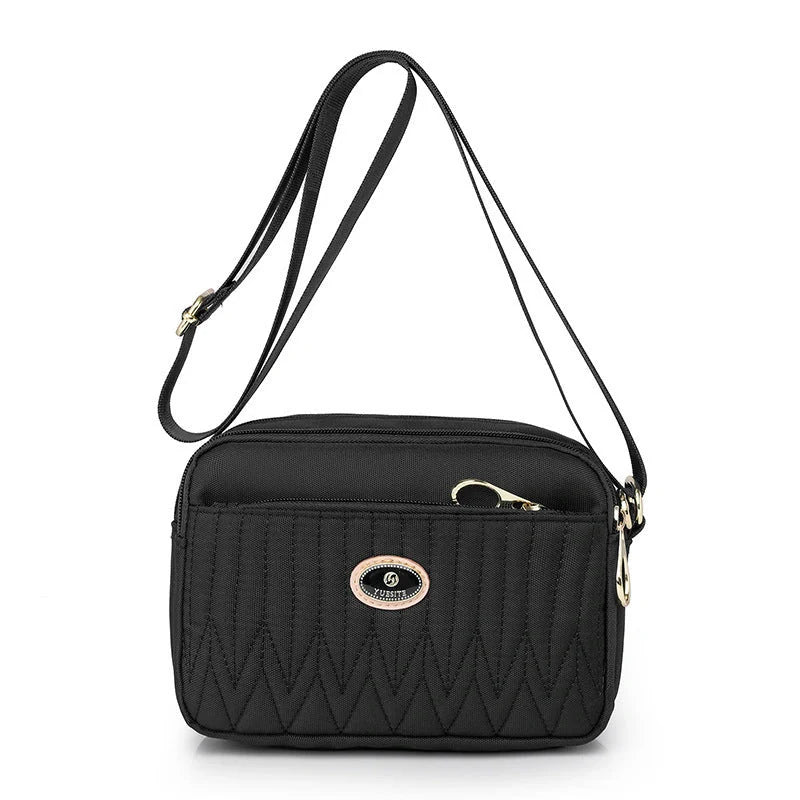 Compact nylon messenger bag for women in various colours with adjustable strap