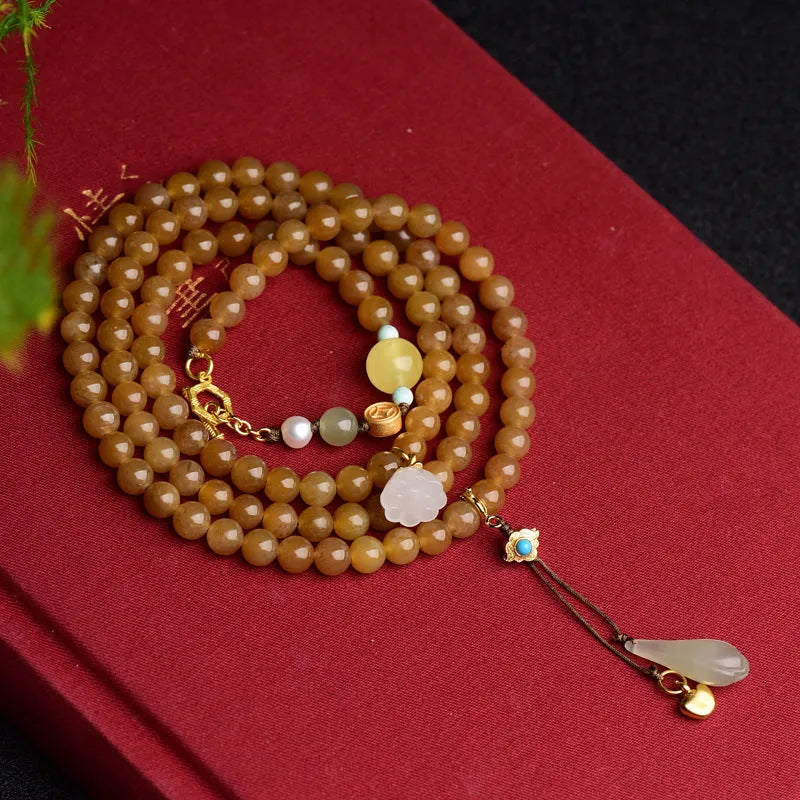 Women's green pine bead bracelet with jade leaves and sequin details on wrist