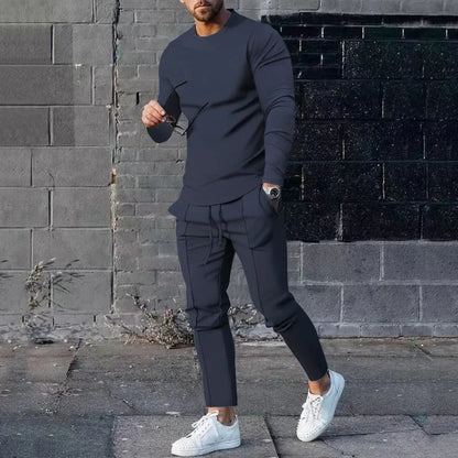 Men's solid colour two-piece lounge suit with long sleeve T-shirt and trousers in light grey.