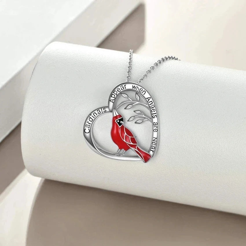 Elegant heart-shaped cardinal pendant necklace with a silver finish, perfect for gifting.