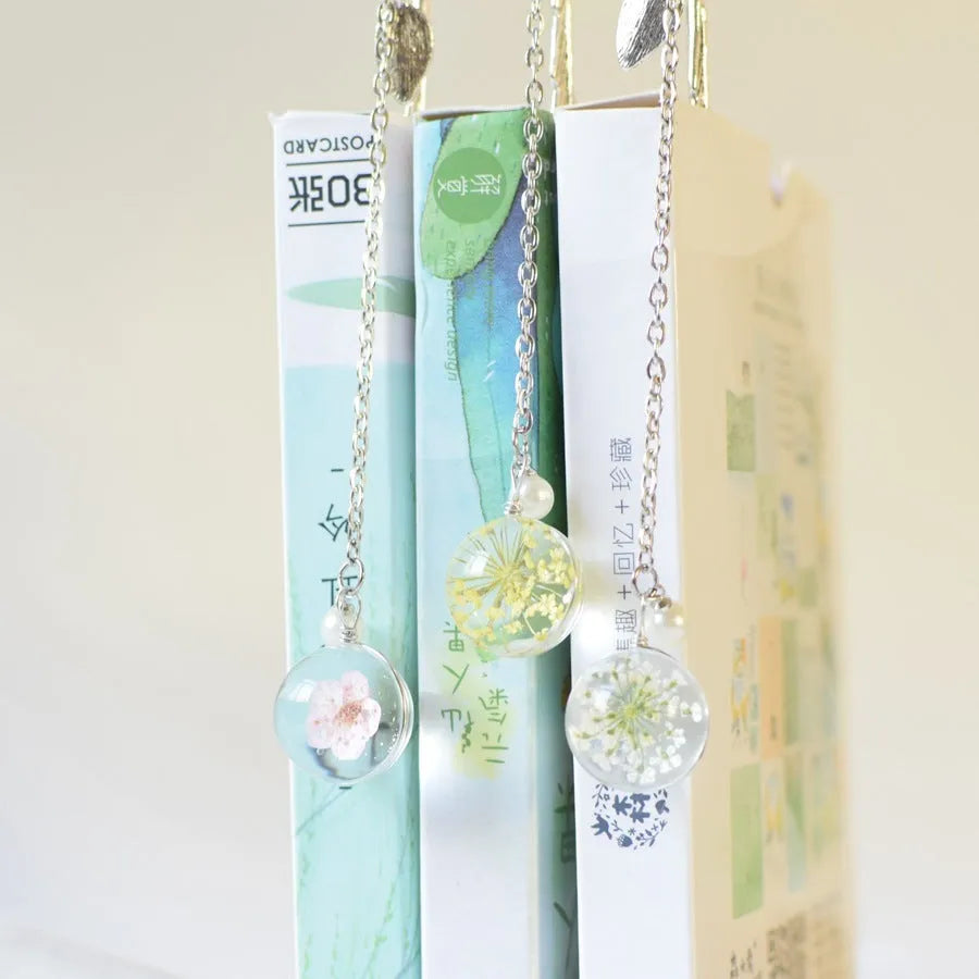Dried flower bookmark with alloy frame measuring 12cm by 2cm, showing preserved botanical specimens