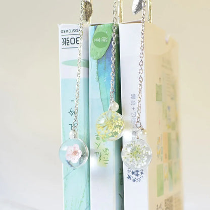 Dried flower bookmark with alloy frame measuring 12cm by 2cm, showing preserved botanical specimens