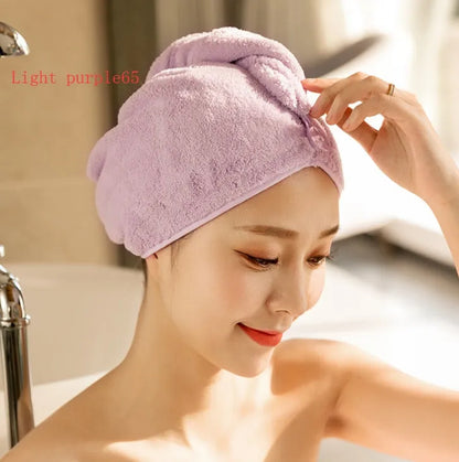 A woman wearing a sky blue microfiber hair dryer cap, with wet hair tucked inside, showing the towel's wrap-around design.