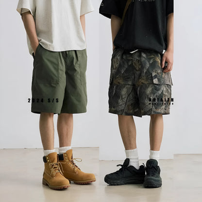 Women's loose fit denim shorts in army green colour, showing straight-leg cut and zip placket.