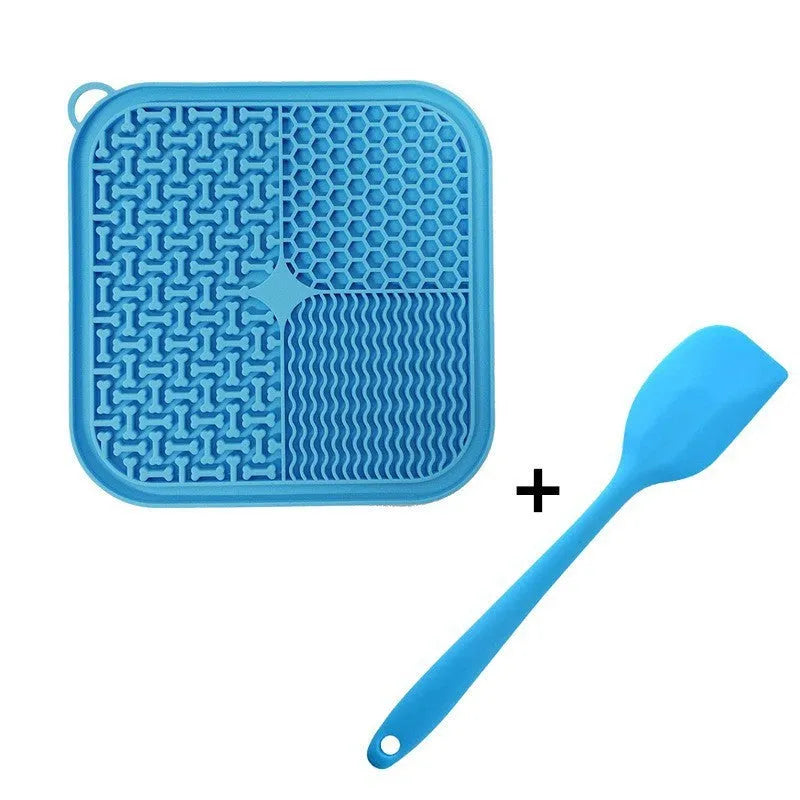Square orange, grey, blue, and green silicone dog licking mat with suction cups on the base.