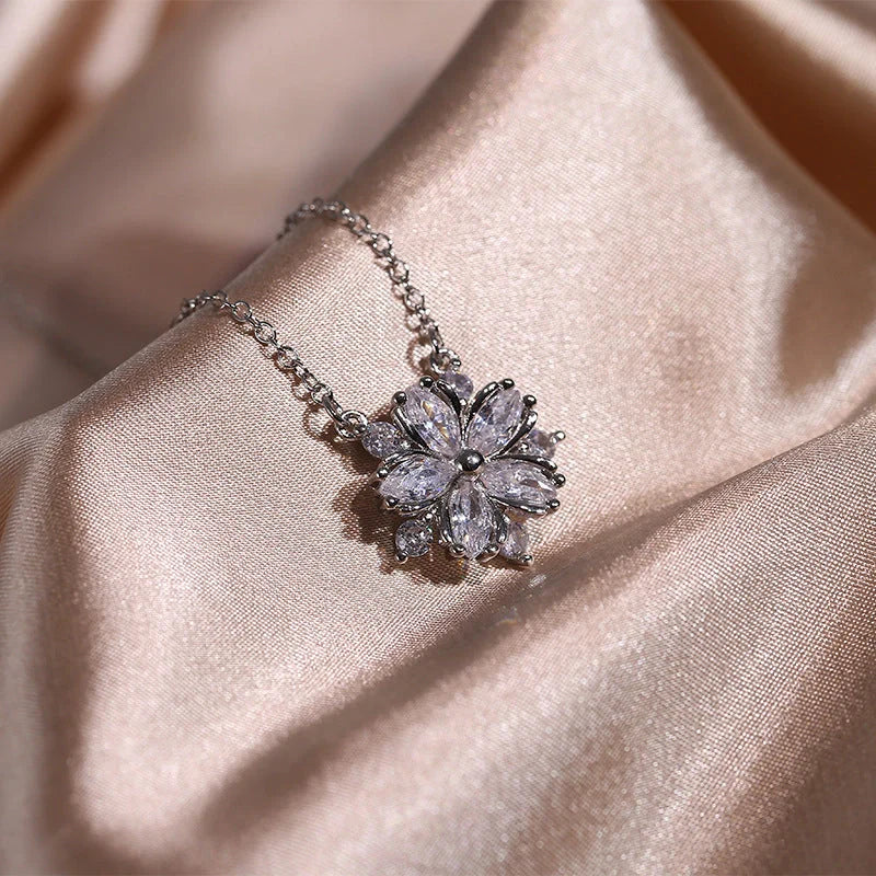 Dazzling cubic zirconia jewellery set with double-layered flower design, including ring, necklace, and earrings in pink and white diamond colours