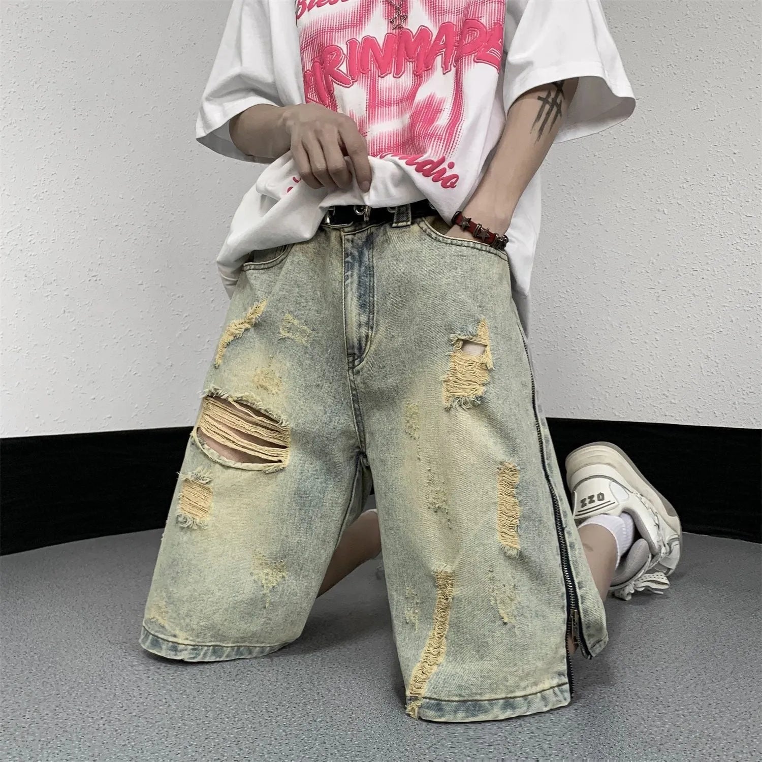Men's blue denim shorts with retro yellow mud ripped detailing and button-front cardigan closure