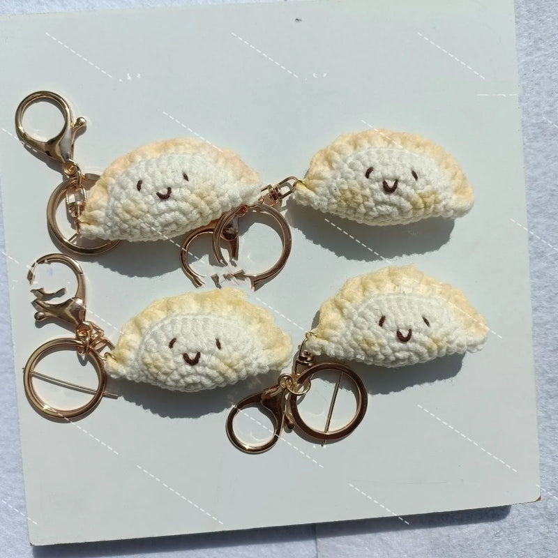 Crochet spring festival dumpling pendant with keychain, handmade from plush material, featuring hand-stitched decorative eyes in a choice of three styles: Doudou Eye, hand-sewn eye, or two hand-sewn eyes.