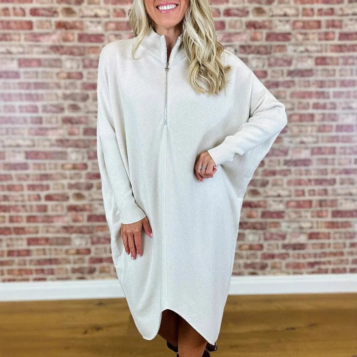 Women's solid colour loose knitted dress with a front zipper and raglan sleeves.