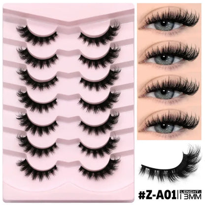 Box containing six pairs of black artificial fibre false eyelashes with different styles and a tube of clear lash glue.