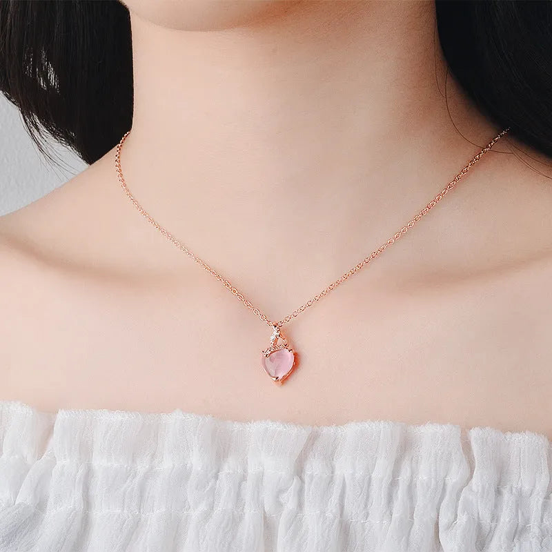 Women's rose gold heart-shaped pendant necklace with pink crystal centre on cross chain