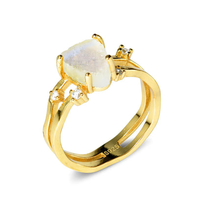 S925 sterling silver ring with an irregular triangular bezel holding a genuine cabochon moonstone, on a model's finger.