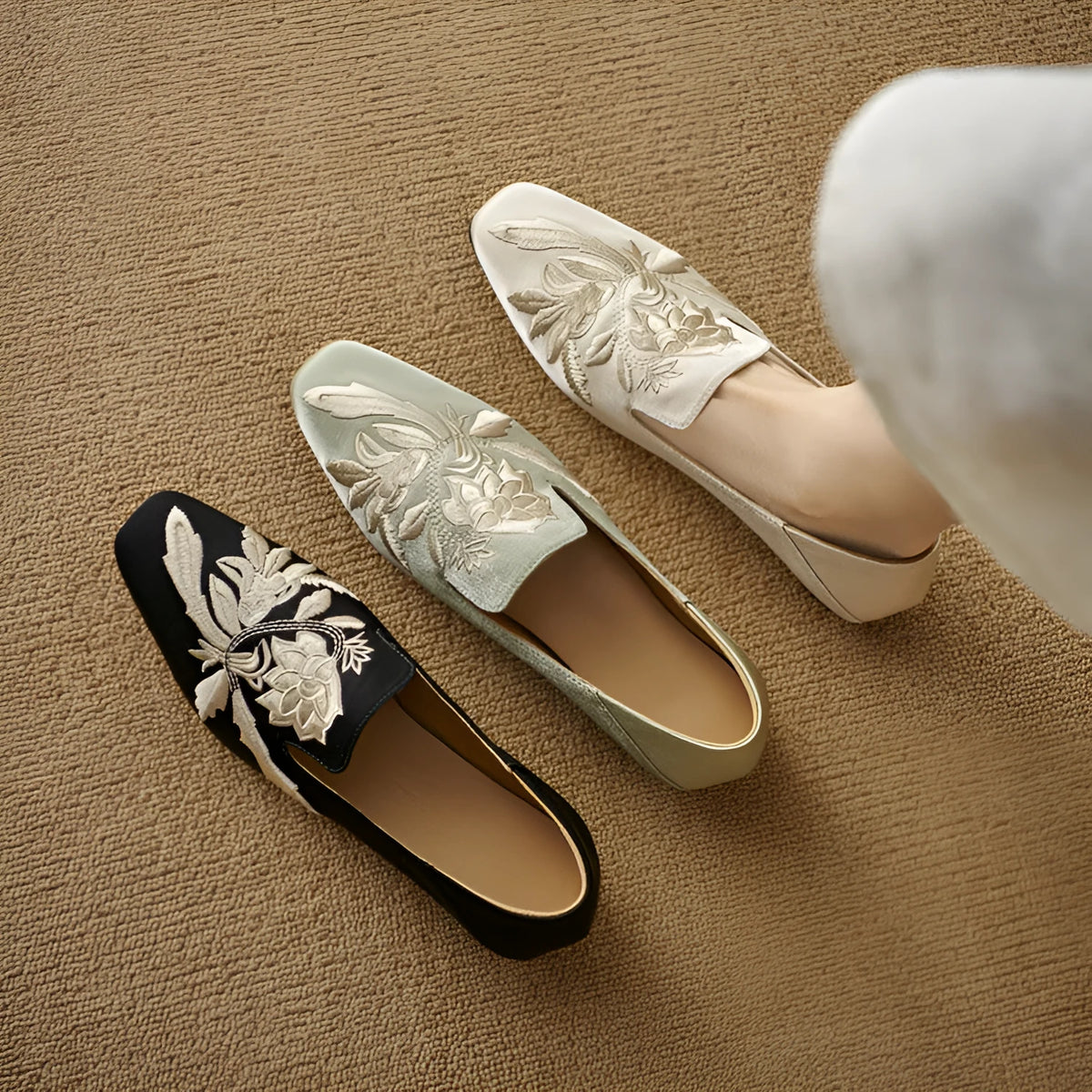 Women's embroidered low-cut flat pumps in beige with a round toe and soft sole.
