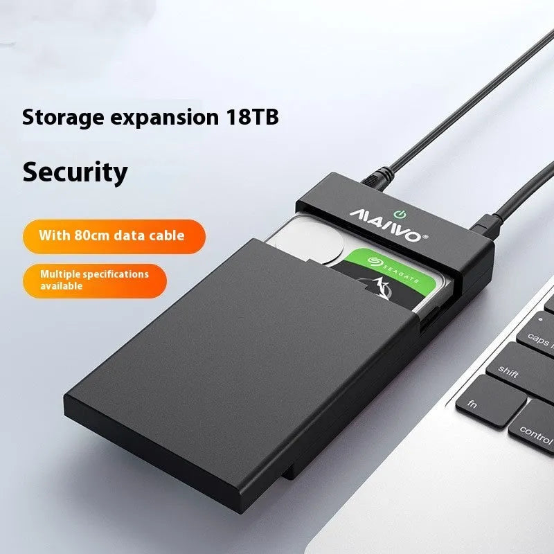 Black and silver 3.5-inch SATA hard disk enclosure with USB 3.0 cable and power adapter on a desk