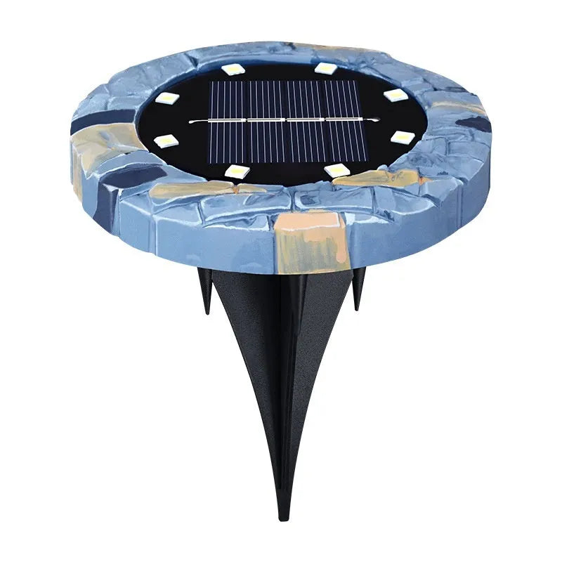 Stainless steel solar garden ground lamp installed in a lawn.