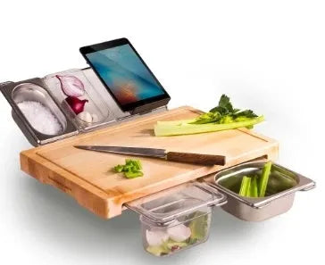 Bamboo cutting board with smooth surface alongside two large and three small plastic storage trays for vegetables and meat.