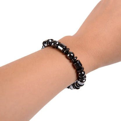 Black pentagram stone magnetic therapy bracelet with magnetite and hematite beads on a stretch band.