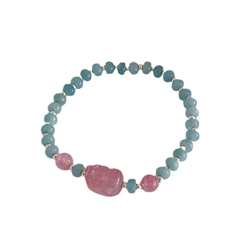Simple blue jade bracelet with gourd charm, peace buckle, and adjustable cord on woman's wrist