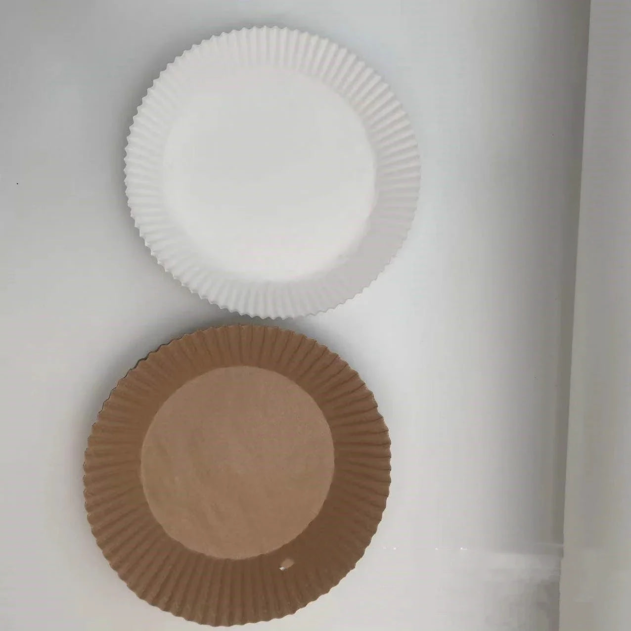 Disposable air fryer liners made from high-quality parchment paper, designed to keep your air fryer clean and your meals healthy