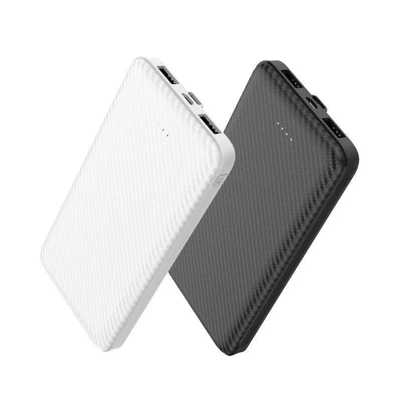 White portable power bank with 20000mAh capacity and multiple USB output ports on a table.
