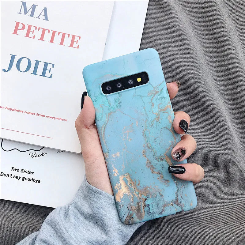 Samsung phone case with white and grey marble pattern on a polycarbonate back cover.