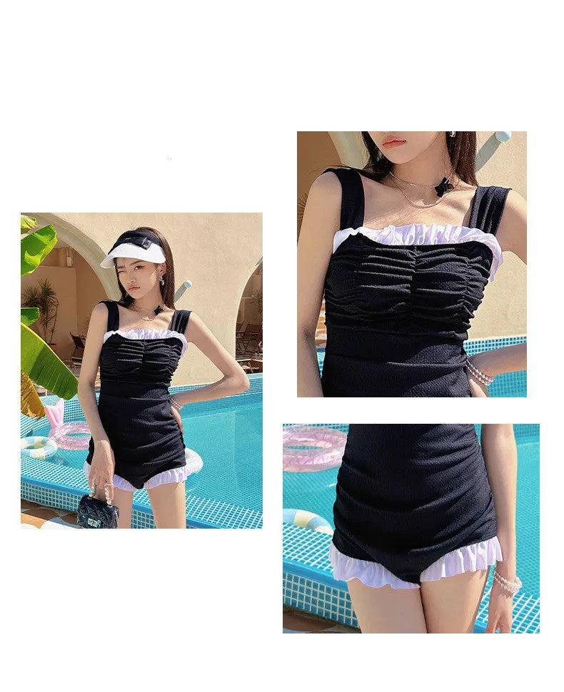 Women's solid colour one-piece swimsuit with suspender straps in a jumpsuit style.