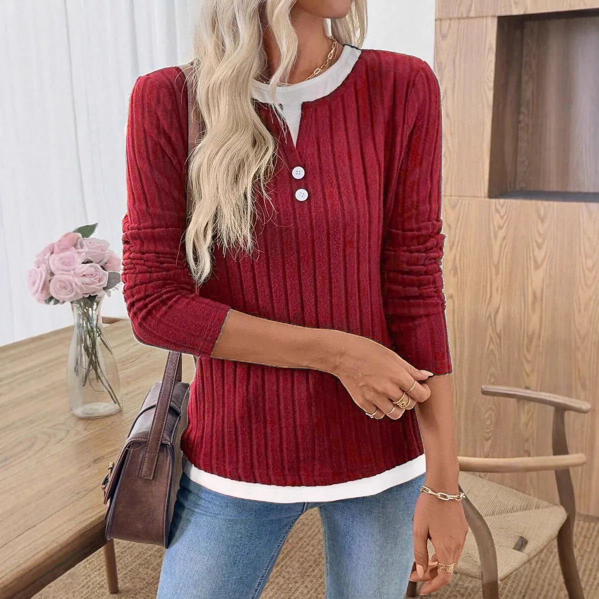 Women's black fake two-piece pullover sweater with concave stripe texture and round neck.