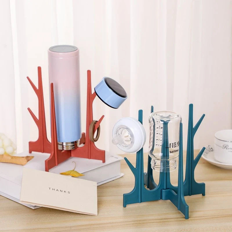 Creative Tree Branch Bottle Drying Rack for baby feeding bottles and accessories in blue, yellow, white, and nude
